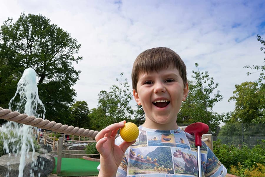 Child playing mini golf