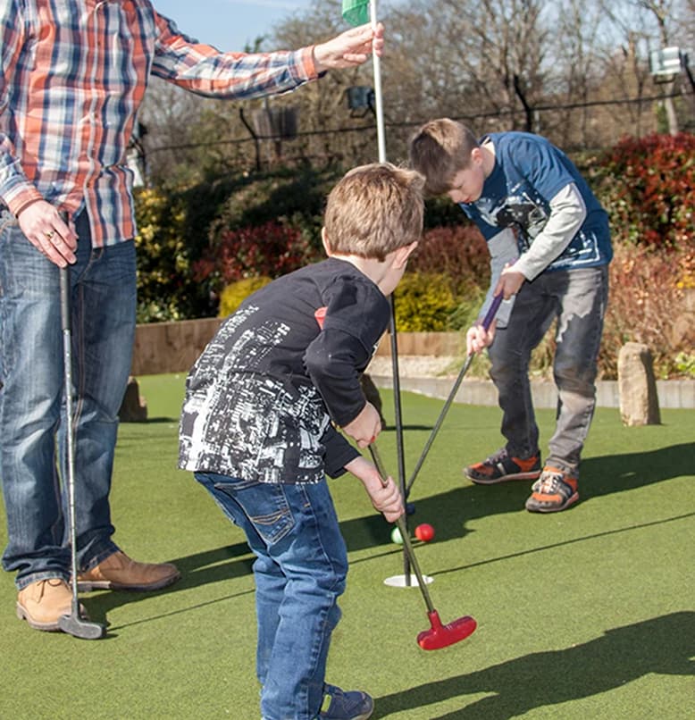 Children playing mini golf